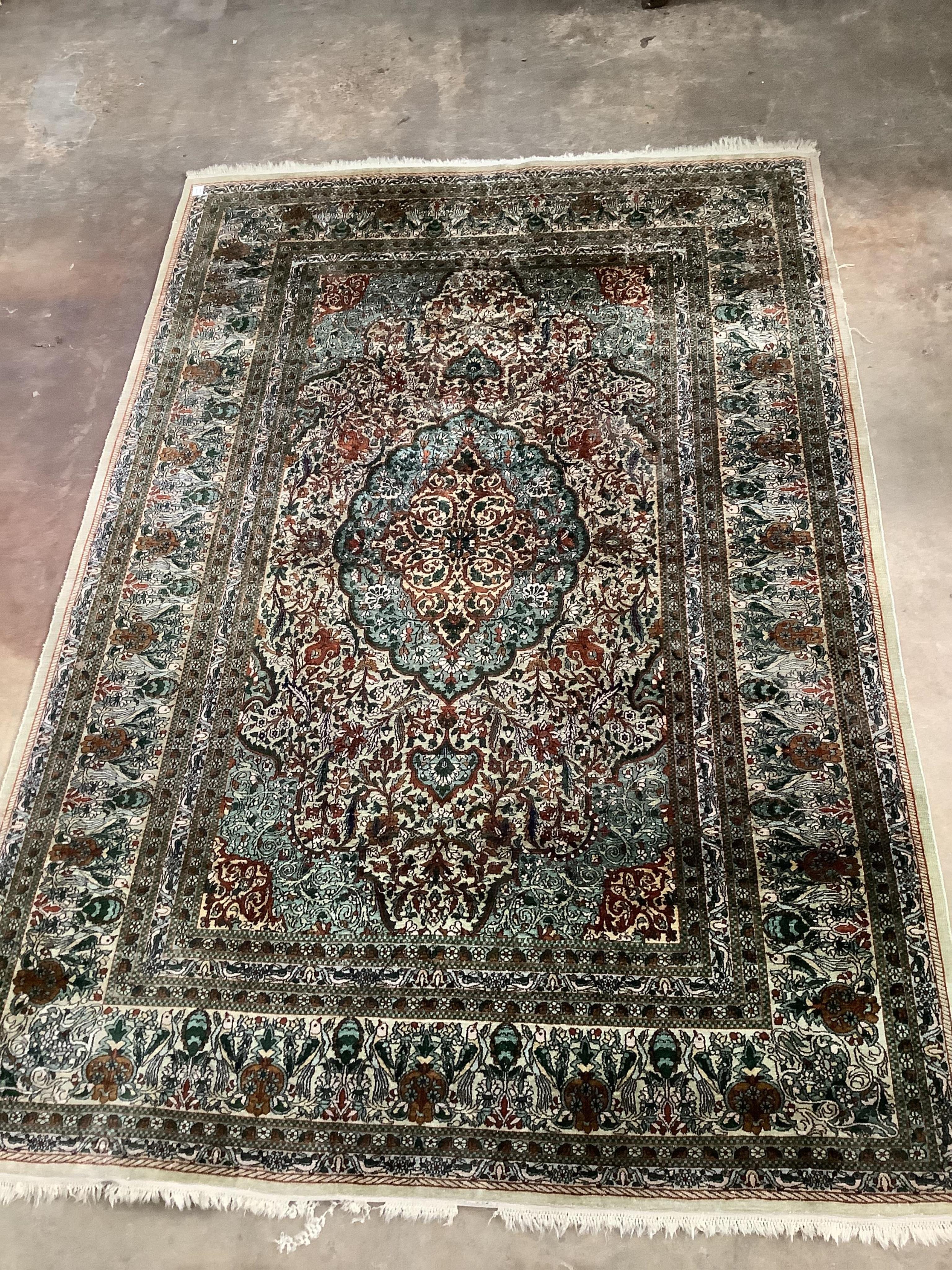 A Persian design ivory ground rug, 272 x 182cm. Condition - fair